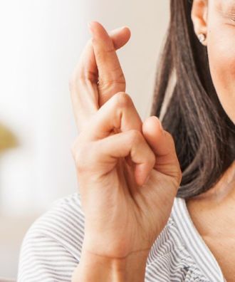 Woman's crossed fingers